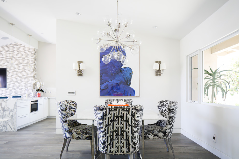 This is an example of a mid-sized contemporary open plan dining in Orange County with white walls and light hardwood floors.