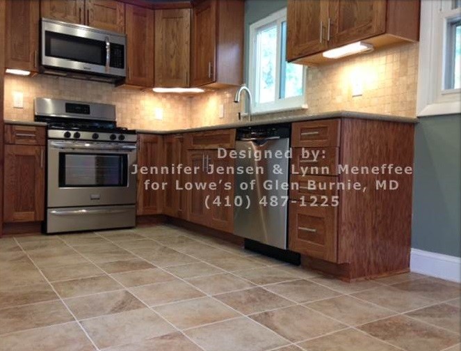 Inspiration for a mid-sized transitional l-shaped porcelain tile home design remodel in Baltimore with no island, shaker cabinets, medium tone wood cabinets, quartz countertops, beige backsplash, stone tile backsplash, stainless steel appliances and an undermount sink