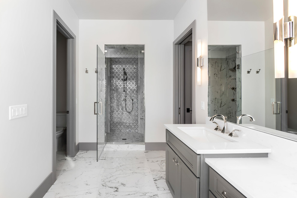 Contemporary master bathroom in Denver with grey cabinets, white walls and white benchtops.