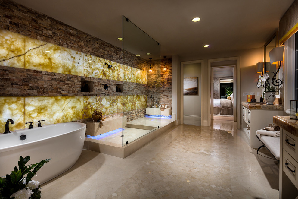 Expansive mediterranean master bathroom in San Diego with beaded inset cabinets, beige cabinets, a freestanding tub, a corner shower, brown tile, yellow tile, stone tile, beige walls, beige floor, an open shower and brown benchtops.