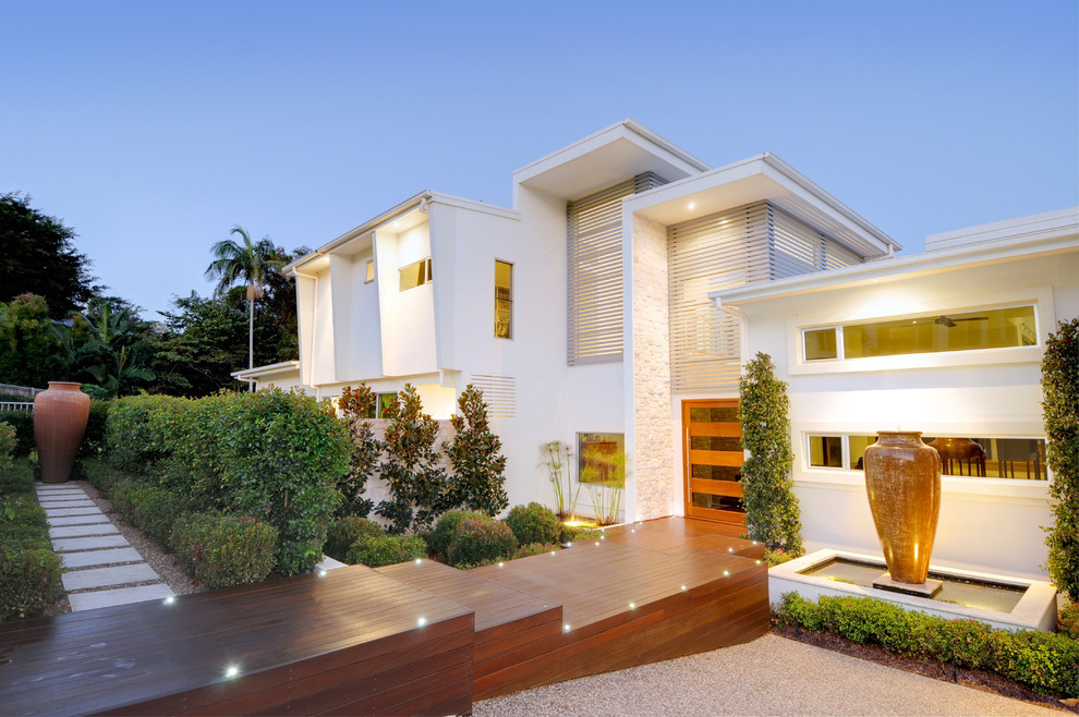 This is an example of a mid-sized modern two-storey stucco white exterior in Sunshine Coast.