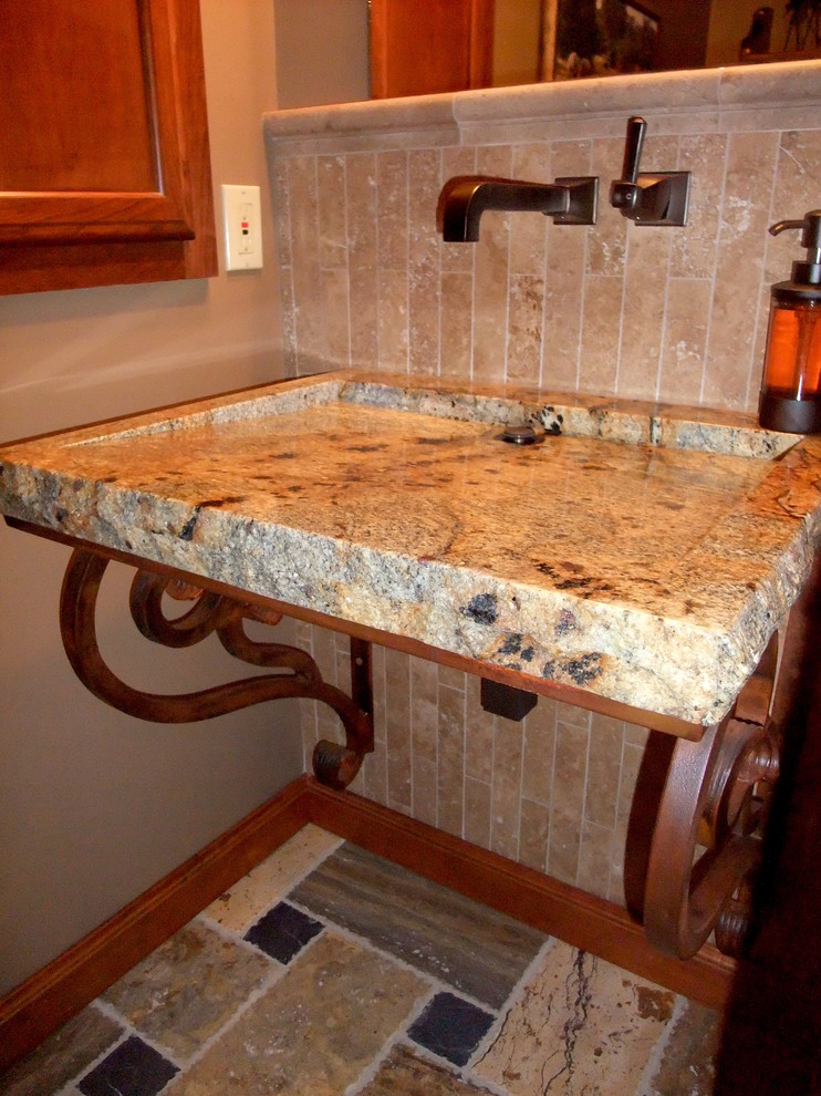 Example of a small mountain style beige tile and travertine tile travertine floor and multicolored floor home design design with beige walls, a wall-mount sink and granite countertops