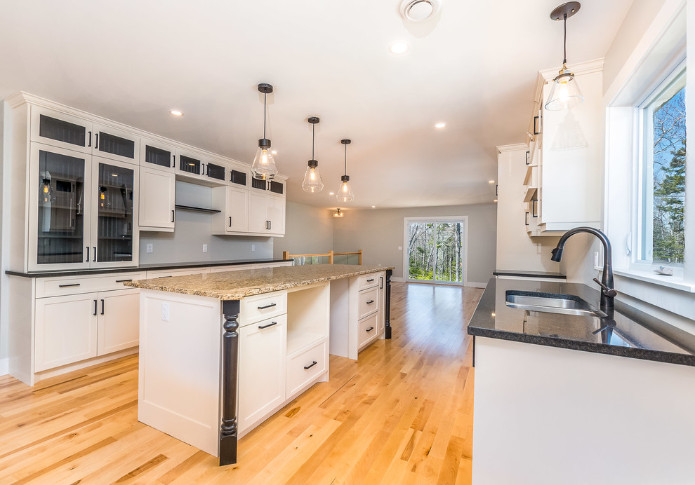 Inspiration for a large transitional light wood floor and beige floor eat-in kitchen remodel