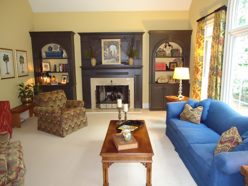 Traditional open concept living room in Other with a wood fireplace surround.
