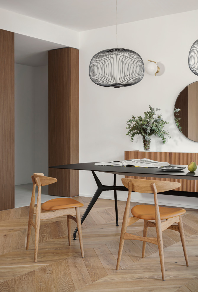 Diseño de comedor moderno grande abierto con paredes blancas, suelo de madera en tonos medios y panelado