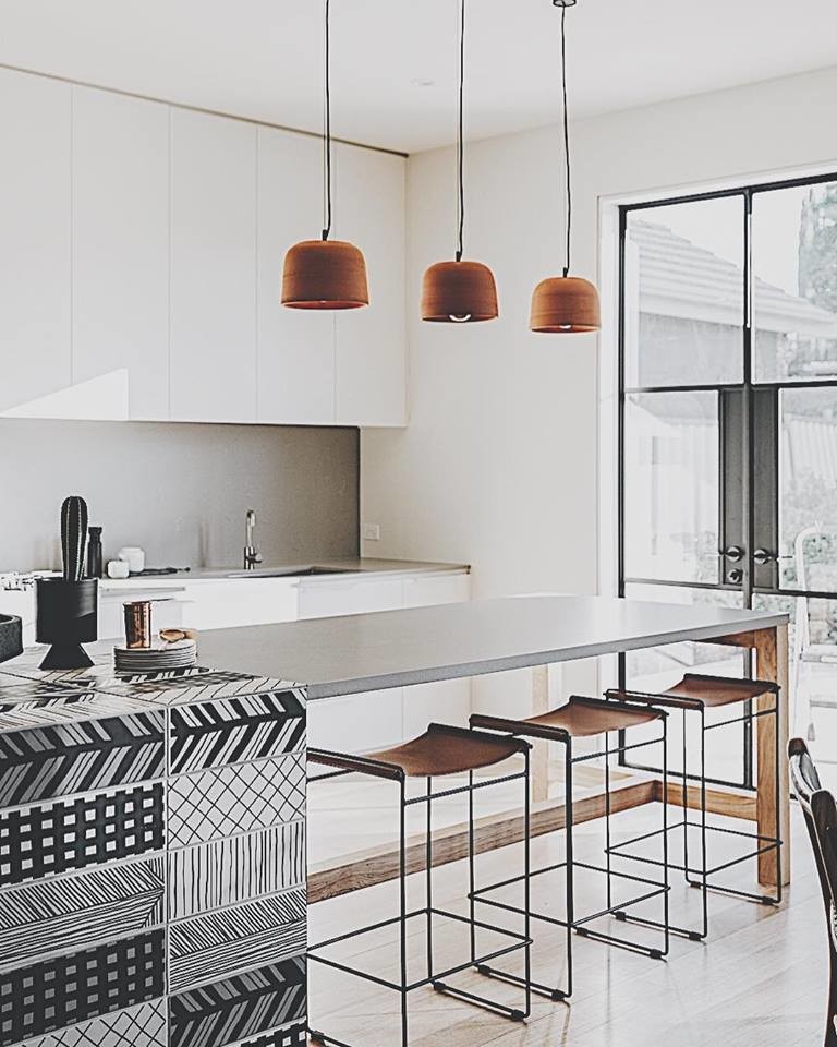 Inspiration for a small eclectic galley eat-in kitchen in Adelaide with white cabinets, tile benchtops, grey splashback, with island, grey benchtop, a drop-in sink, glass tile splashback, black appliances, travertine floors and grey floor.