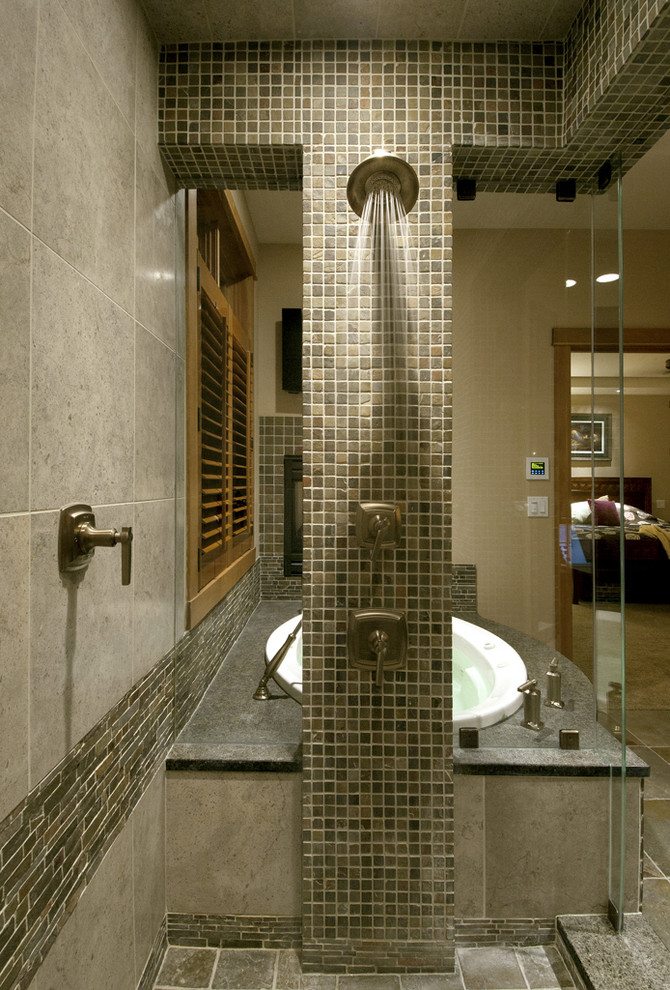 Design ideas for a large contemporary master bathroom in Seattle with raised-panel cabinets, dark wood cabinets, a drop-in tub, a corner shower, beige tile, brown tile, gray tile, multi-coloured tile, stone tile, beige walls, mosaic tile floors and granite benchtops.