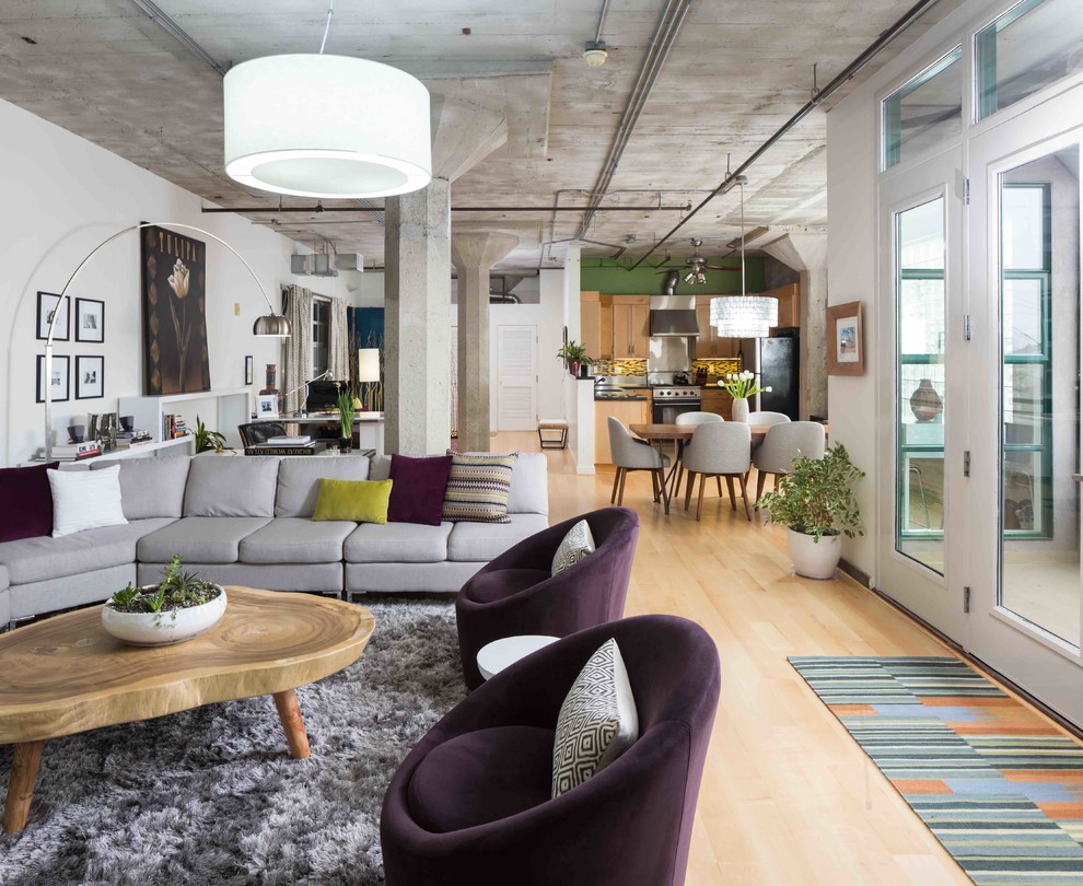 Industrial loft-style living room in San Francisco with light hardwood floors.