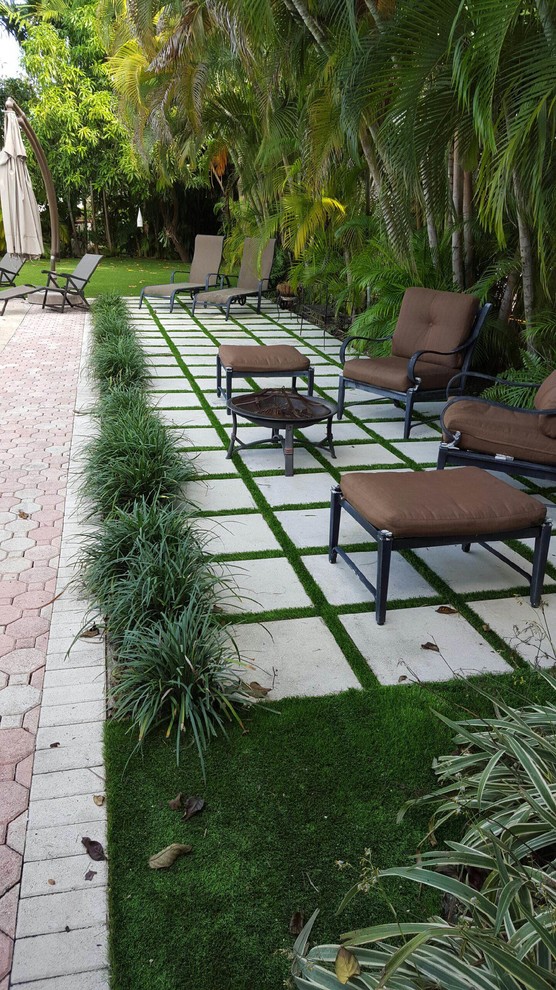 Large traditional backyard patio in Miami with stamped concrete.