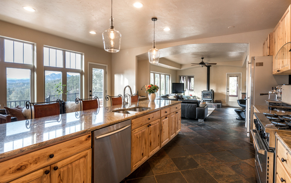Photo of a large traditional galley open plan kitchen in Denver with an undermount sink, granite benchtops, beige splashback, stainless steel appliances and with island.