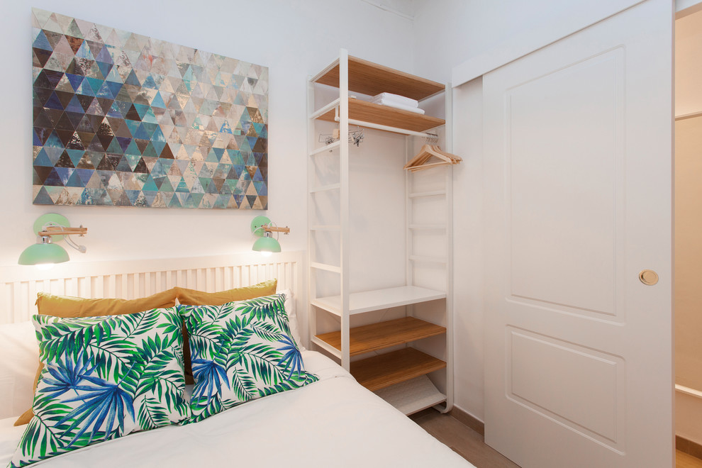 Inspiration for a small scandinavian master bedroom in Barcelona with white walls, ceramic floors and brown floor.