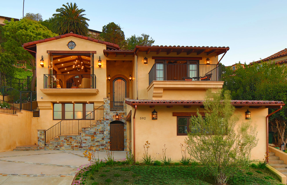 Design ideas for a mediterranean two-storey yellow exterior in Los Angeles.