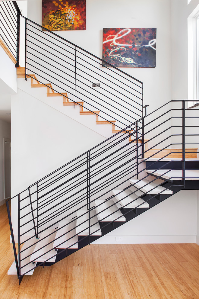 Design ideas for a contemporary l-shaped staircase in Austin with open risers.