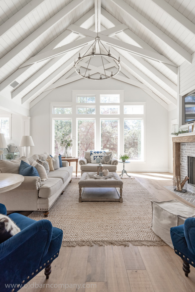 Inspiration for a large cottage light wood floor, vaulted ceiling and shiplap wall family room remodel in Dallas with white walls, a standard fireplace, a tile fireplace and a wall-mounted tv