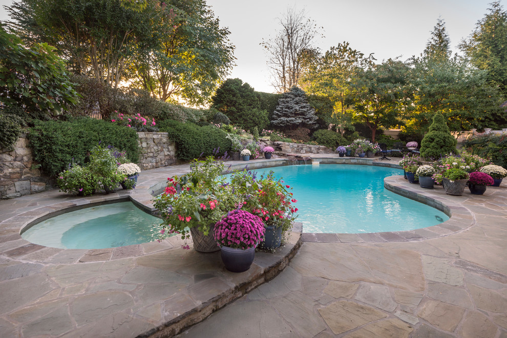 Photo of a small contemporary backyard pool in DC Metro with natural stone pavers.