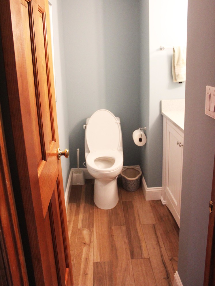 Photo of a small traditional powder room in New York with blue walls.