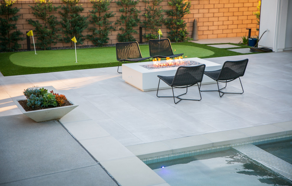 Photo of a large transitional backyard rectangular pool in San Diego with with a pool and tile.