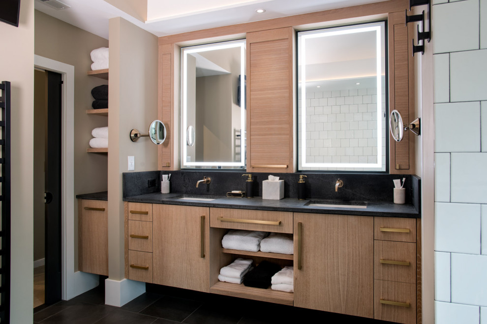 Inspiration for a contemporary master bathroom in Richmond with light wood cabinets, a double shower, black and white tile, beige walls, an undermount sink, granite benchtops, grey floor, black benchtops, an enclosed toilet, a double vanity, a floating vanity and vaulted.