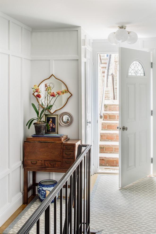 Design ideas for a small transitional foyer in DC Metro with white walls, light hardwood floors and brown floor.