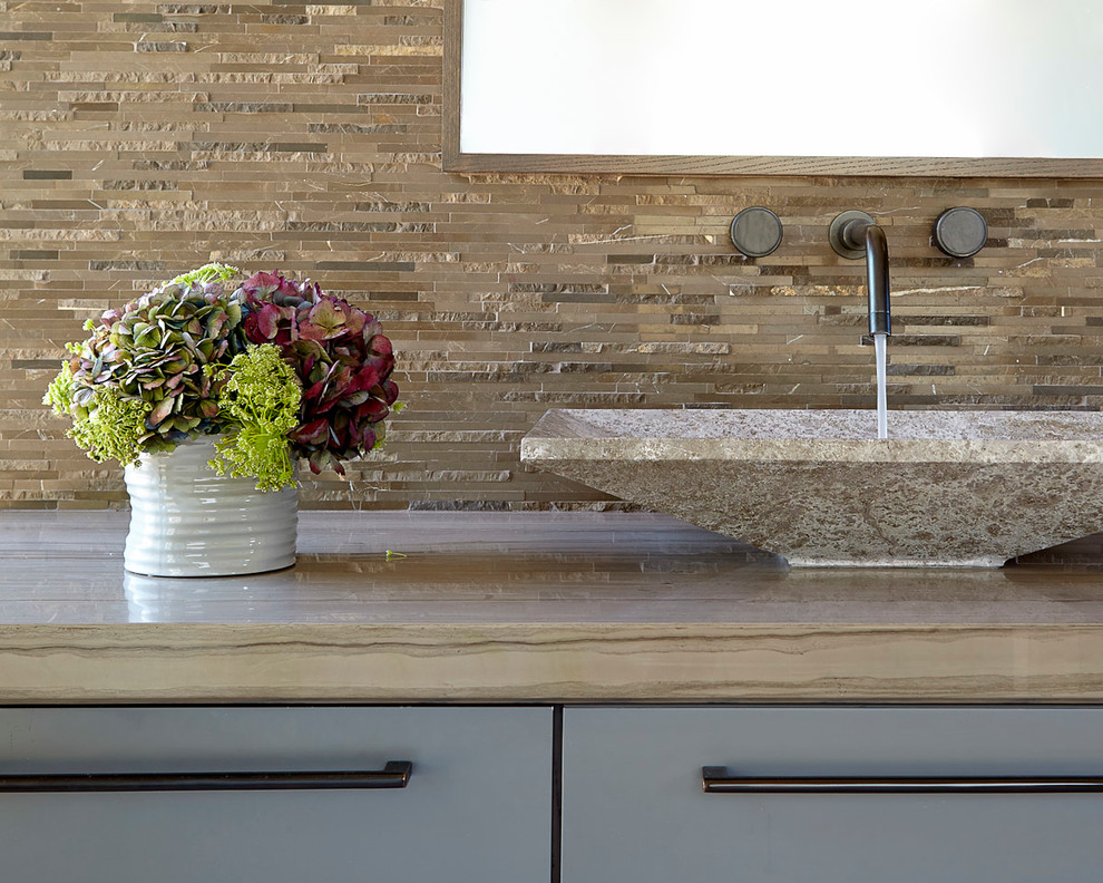 Mid-sized minimalist 3/4 multicolored tile and glass tile marble floor and beige floor freestanding bathtub photo in San Francisco with a vessel sink, flat-panel cabinets, gray cabinets, quartzite countertops, a two-piece toilet, beige walls and a hinged shower door