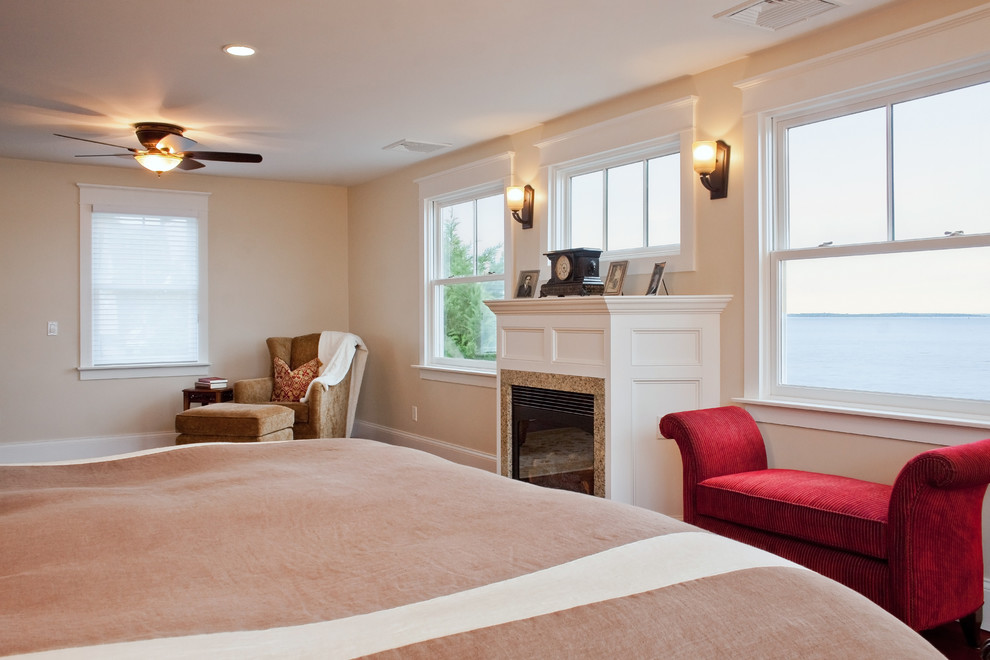 This is an example of a mid-sized transitional master bedroom in Other with beige walls, dark hardwood floors, a standard fireplace, a tile fireplace surround and brown floor.