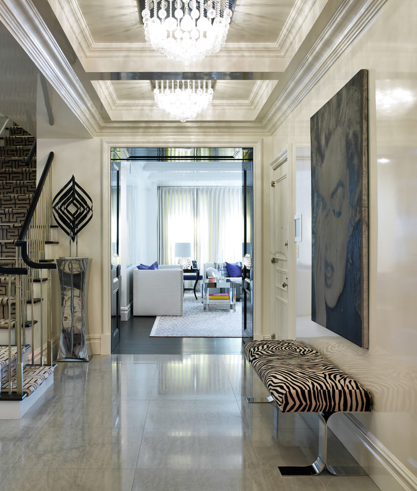 This is an example of a transitional foyer in New York with beige walls and concrete floors.