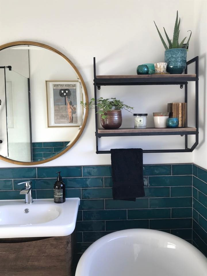 Photo of a mid-sized traditional kids wet room bathroom in Other with furniture-like cabinets, brown cabinets, a freestanding tub, a two-piece toilet, green tile, ceramic tile, white walls, ceramic floors, a wall-mount sink, black floor and an open shower.