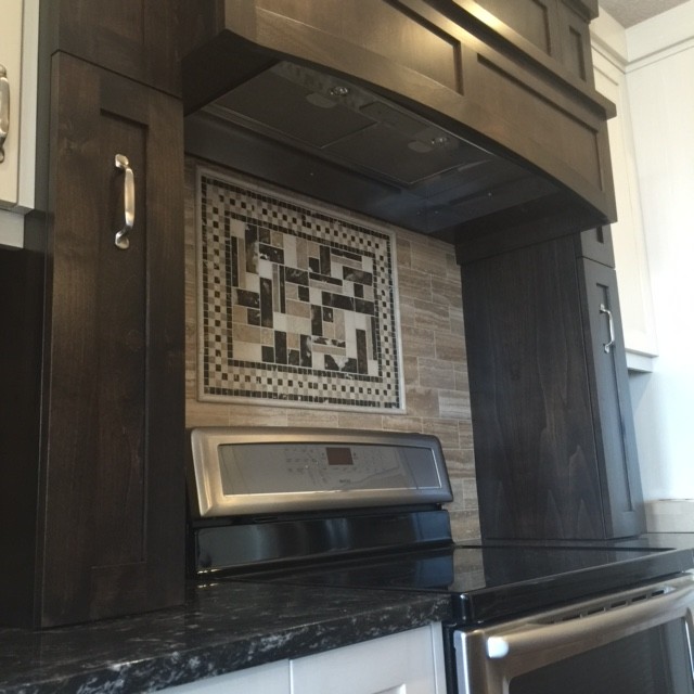 Transitional medium tone wood floor eat-in kitchen photo in Calgary with shaker cabinets, black cabinets, granite countertops and an island