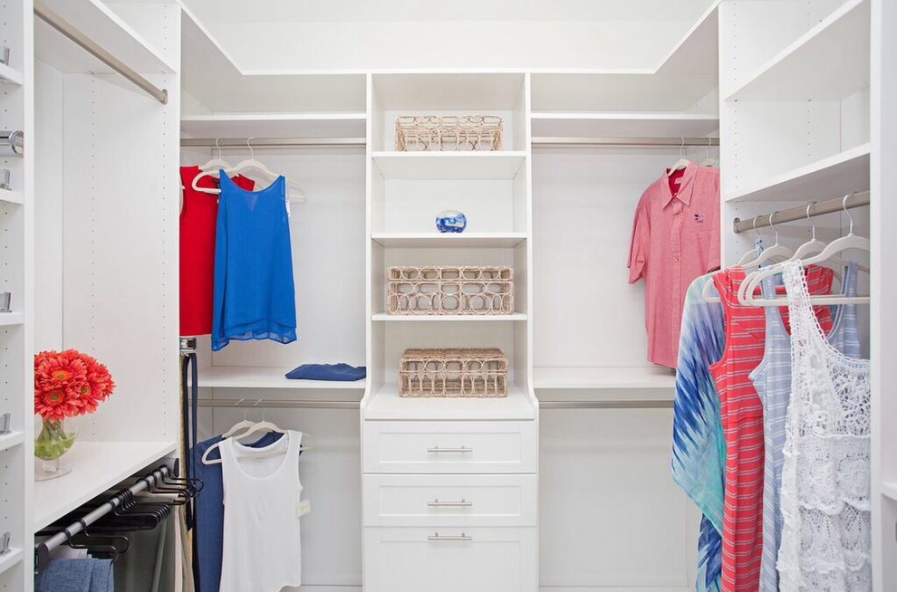 Photo of a mid-sized beach style gender-neutral walk-in wardrobe in Tampa with shaker cabinets and white cabinets.