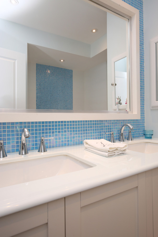 Inspiration for a mid-sized beach style kids bathroom in Toronto with shaker cabinets, white cabinets, a claw-foot tub, a two-piece toilet, blue tile, mosaic tile, blue walls, marble floors, an undermount sink and marble benchtops.