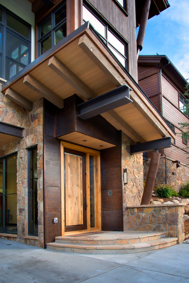 Inspiration for a large contemporary front door in Denver with concrete floors, a single front door and a light wood front door.