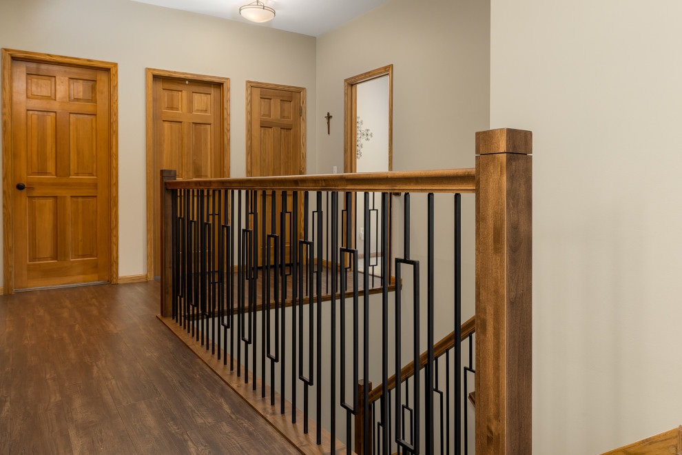 This is an example of a large classic carpeted u-shaped wood railing staircase in Other with carpeted risers.