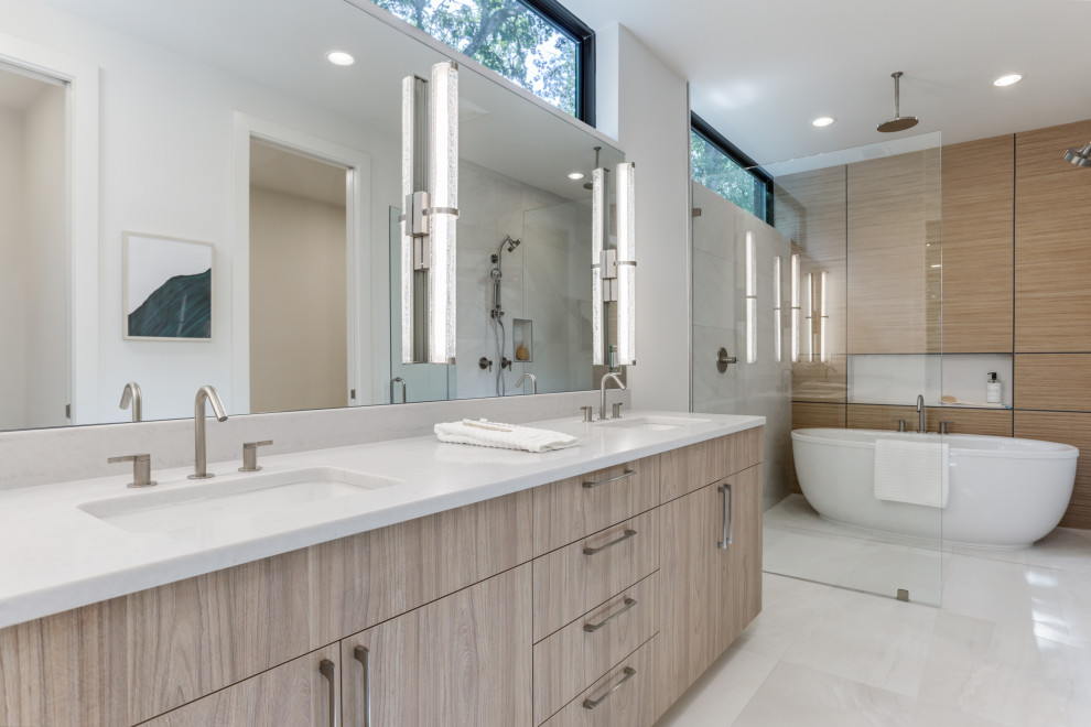 Large contemporary master wet room bathroom in Atlanta with flat-panel cabinets, light wood cabinets, a freestanding tub, white walls, an undermount sink, beige floor, white benchtops, brown tile, wood-look tile, engineered quartz benchtops, a double vanity, a built-in vanity, porcelain floors, a hinged shower door and a niche.