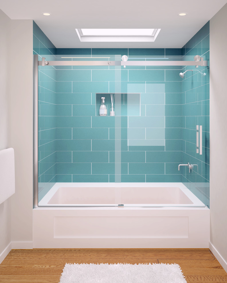 Inspiration for an expansive transitional master bathroom in New York with an alcove tub, an alcove shower, blue tile, glass tile, grey walls and light hardwood floors.
