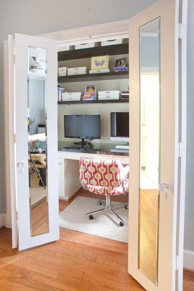 Photo of a mid-sized contemporary home office in Dallas with medium hardwood floors, a built-in desk, beige walls, no fireplace and brown floor.
