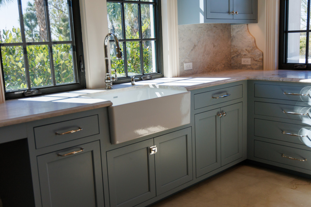 Inspiration for an expansive traditional separated utility room in Tampa with a belfast sink, beaded cabinets, blue cabinets, white walls and beige floors.