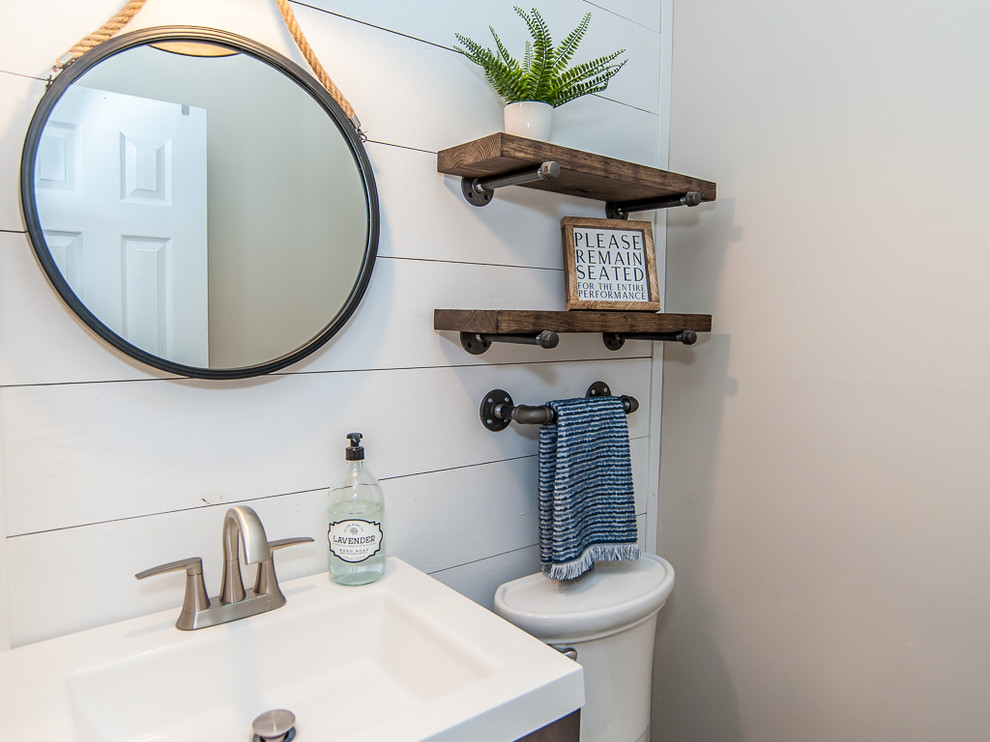 This is an example of a small country bathroom in Raleigh with dark wood cabinets, a two-piece toilet, grey walls, vinyl floors, an integrated sink, wood benchtops and white benchtops.