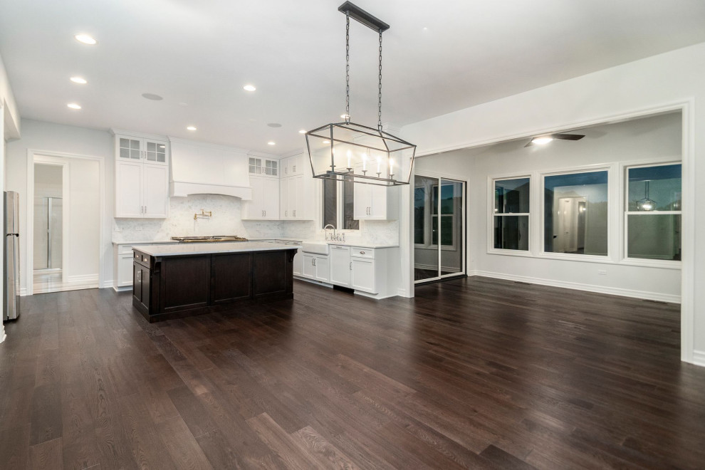 Inspiration for a mid-sized l-shaped dark wood floor and brown floor eat-in kitchen remodel in Chicago with white cabinets, granite countertops, stainless steel appliances and an island