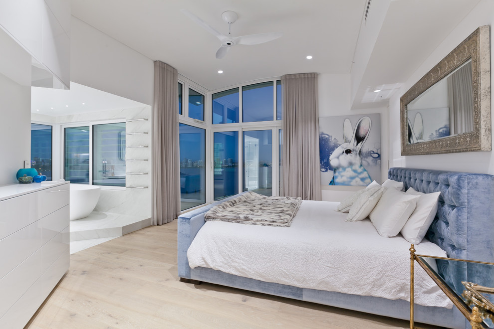 Photo of a large contemporary master bedroom in Perth with white walls, light hardwood floors and beige floor.