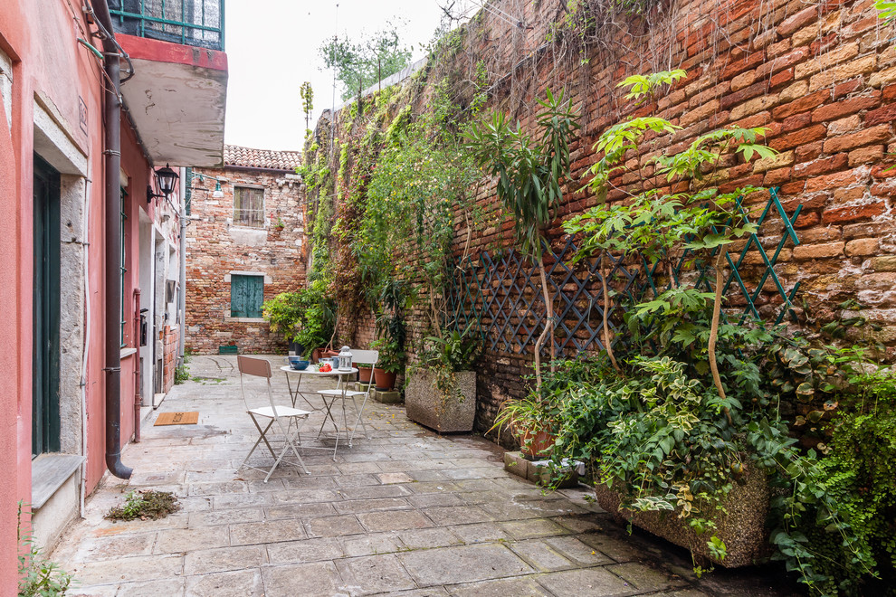 Photo of a mediterranean front yard patio in Venice with a vertical garden.