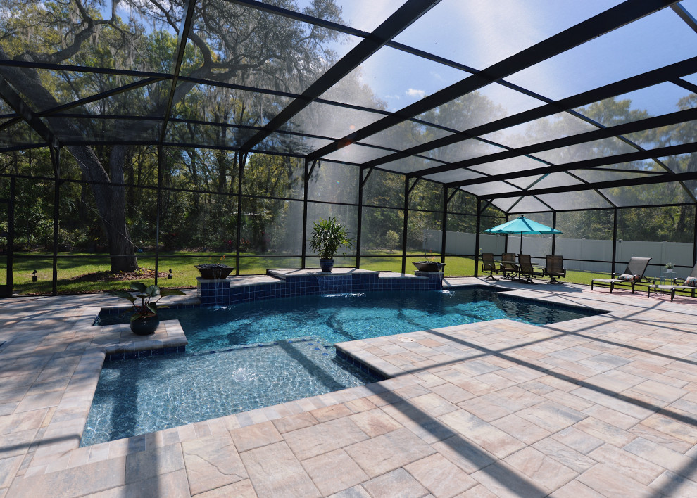 Photo of a mid-sized country backyard rectangular pool in Orlando with brick pavers.