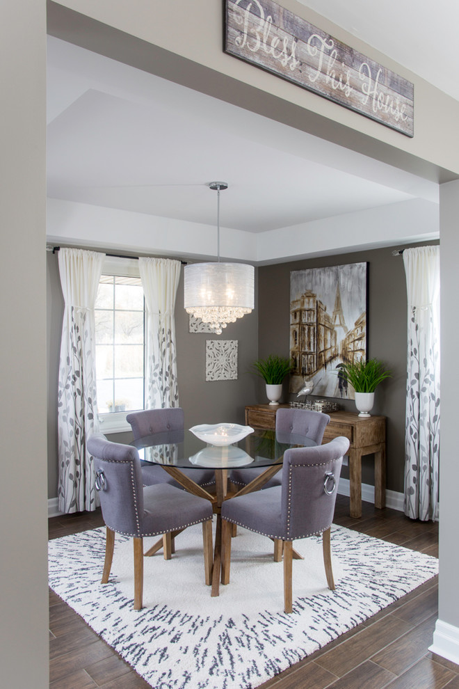 Photo of a transitional separate dining room in Detroit with grey walls and dark hardwood floors.