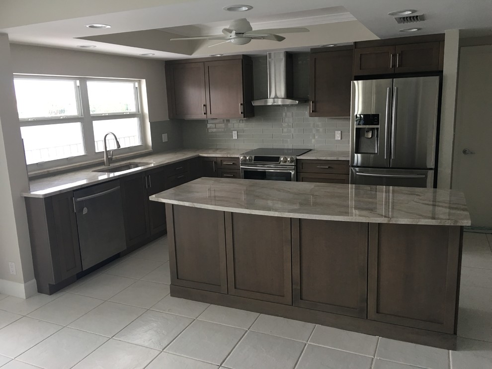 Example of a large transitional l-shaped ceramic tile and white floor kitchen design in Miami with an undermount sink, shaker cabinets, dark wood cabinets, quartzite countertops, gray backsplash, subway tile backsplash, stainless steel appliances and an island