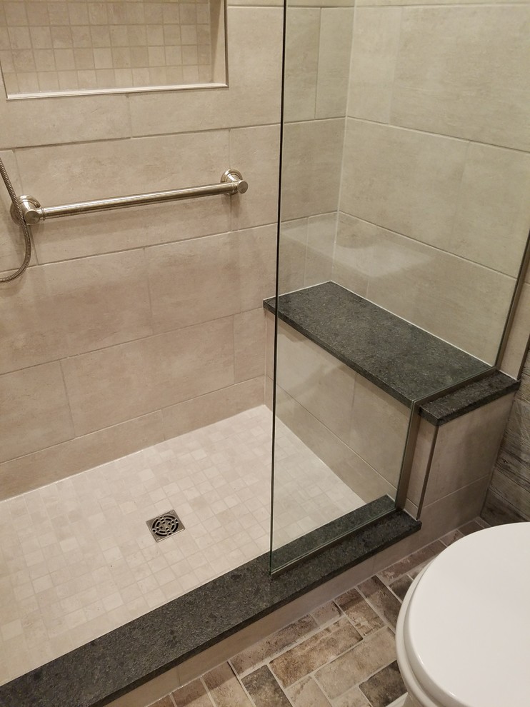 Example of a small mountain style kids' gray tile and porcelain tile porcelain tile and gray floor home design design with furniture-like cabinets, distressed cabinets, a two-piece toilet, gray walls, an undermount sink, granite countertops and a hinged shower door