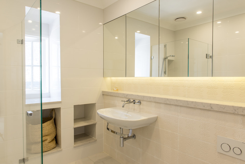 This is an example of a contemporary bathroom in Other with engineered quartz benchtops, white tile, ceramic tile, ceramic floors and a curbless shower.