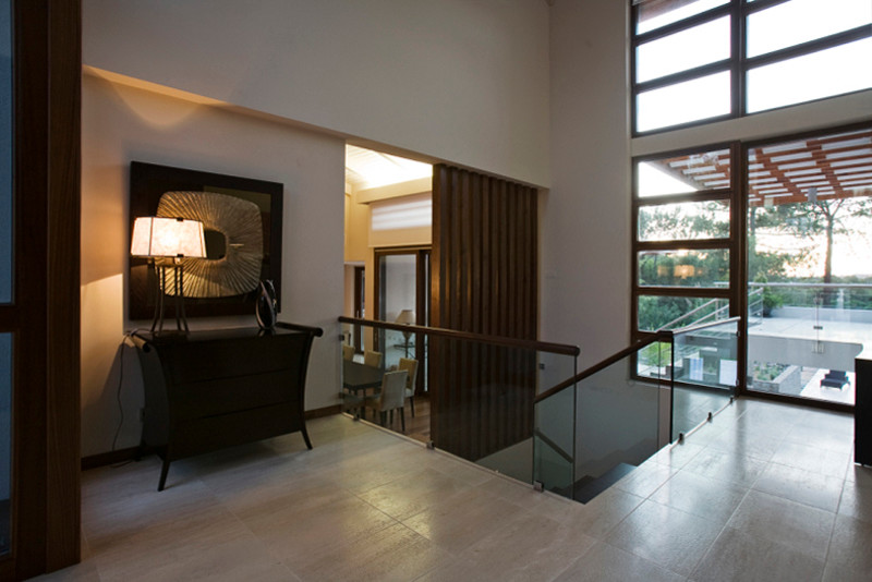 Example of a mid-sized transitional travertine floor hallway design with white walls