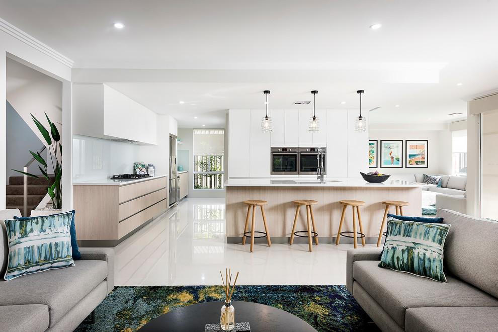Design ideas for a mid-sized contemporary galley open plan kitchen in Perth with a double-bowl sink, flat-panel cabinets, white cabinets, quartz benchtops, stainless steel appliances, ceramic floors and with island.