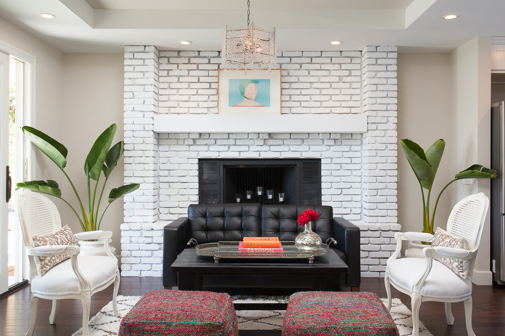Photo of a contemporary formal living room in Orange County with beige walls, dark hardwood floors, a standard fireplace and a brick fireplace surround.