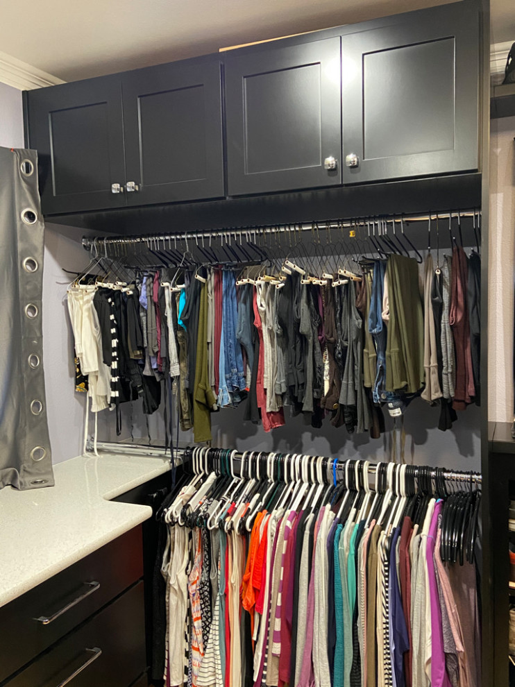 Inspiration for an expansive contemporary dressing room in Denver with recessed-panel cabinets, dark wood cabinets, medium hardwood floors and yellow floor.