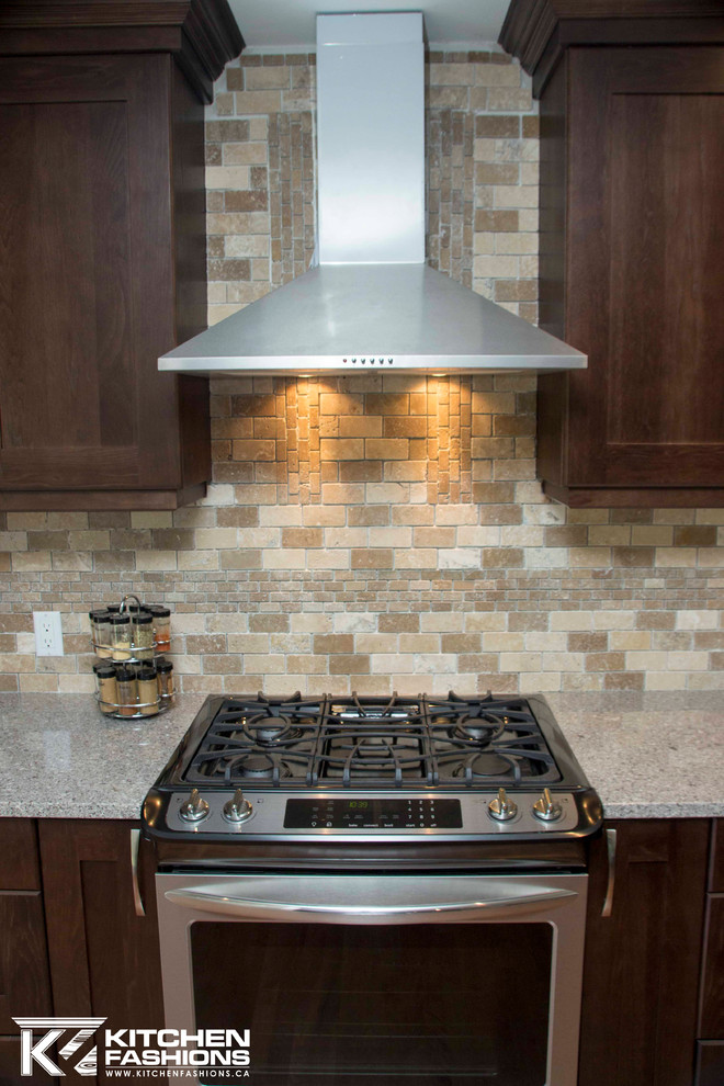Large transitional u-shaped medium tone wood floor open concept kitchen photo with a farmhouse sink, shaker cabinets, dark wood cabinets, quartz countertops, brown backsplash, stone tile backsplash, stainless steel appliances and an island